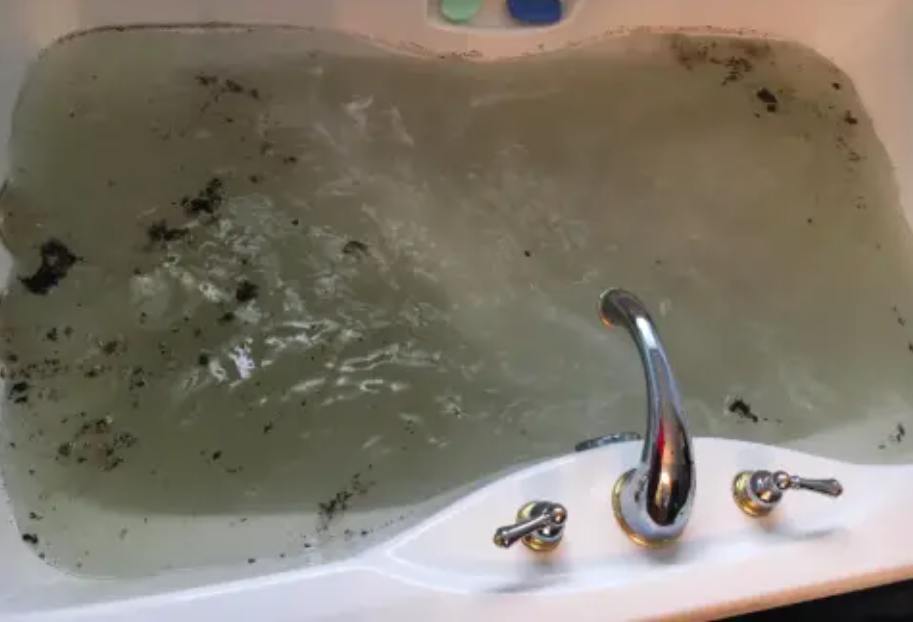 black particles and sludge in jetted tub